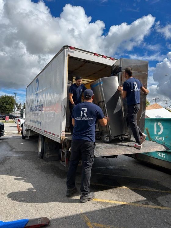 Right Way crew loading a strapped appliance into the moving truck
